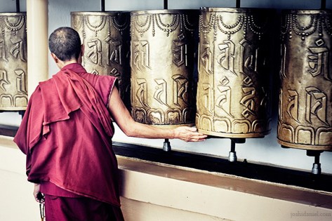 Path to tranquility Buddhist monk rotating a mani Prayer Wheel at McLeod Ganj, Dharamsala, India